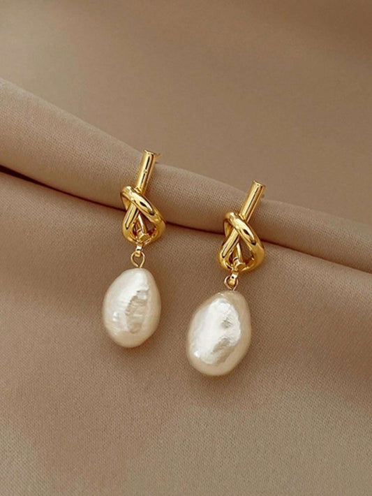 Boucles d'oreilles élégantes de luxe design minimaliste avec perle nouée